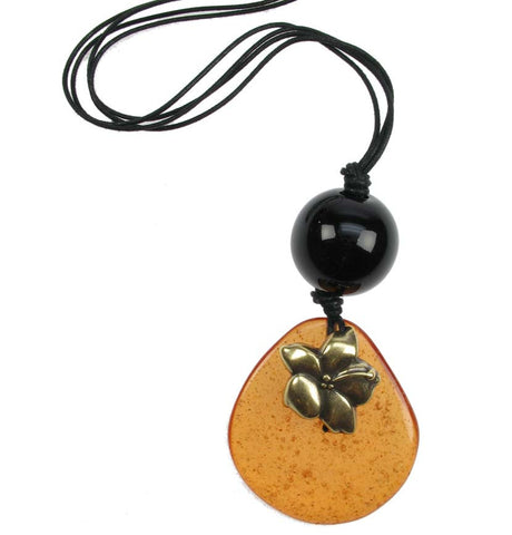 Transparent amber pebble and black bead pendant with gold flower